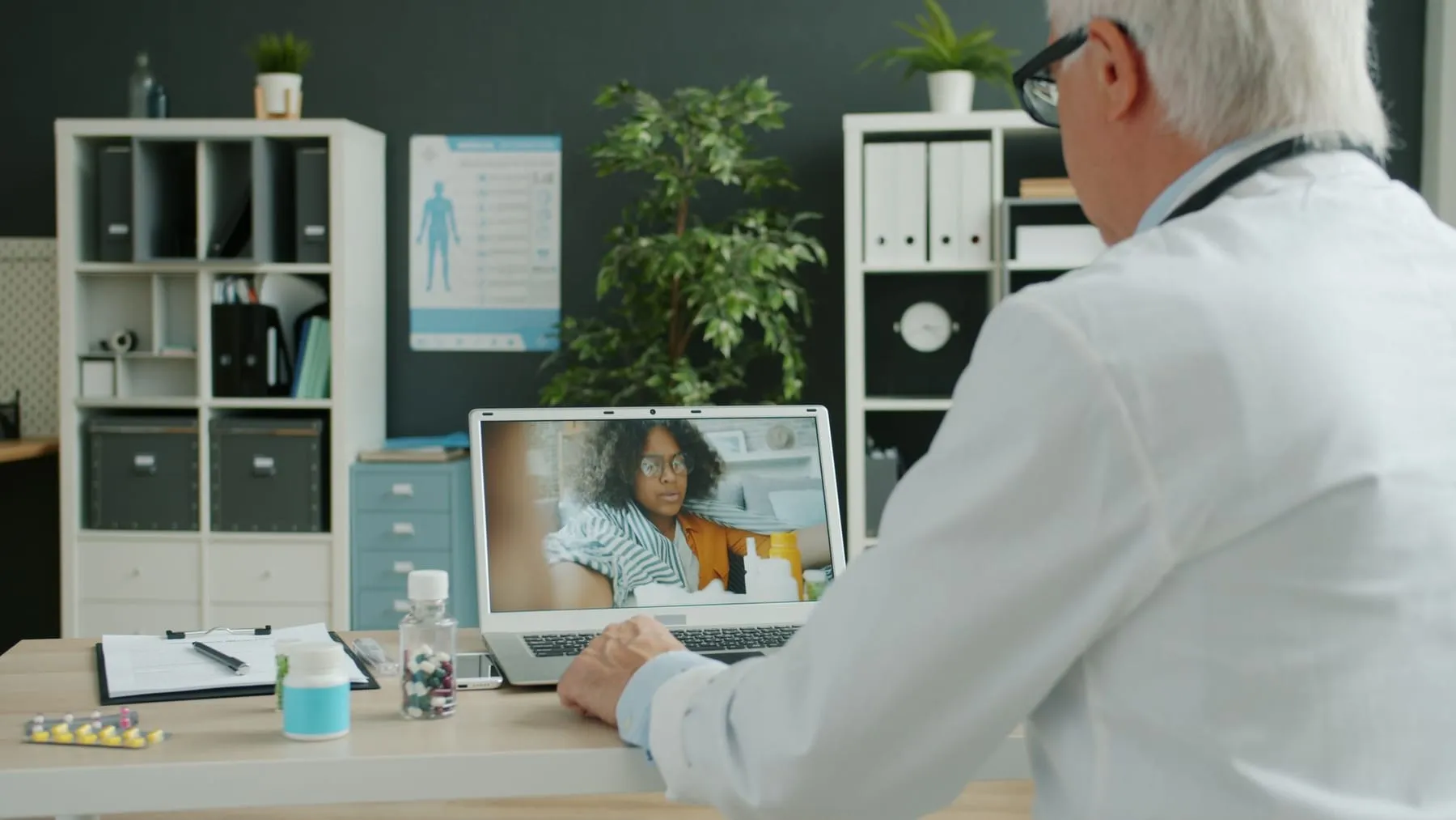A doctor speaking with a patient on a video call